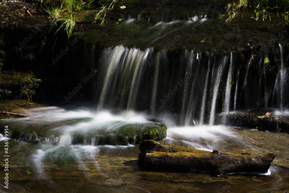Cascading waterfall cascades in Estonia in green light at summertime Cascading waterfall cascades in Estonia in green light at summertime