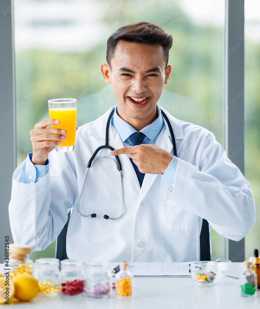 Asian nutritionist showing orange and juice
