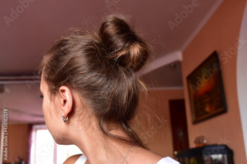 girl with a bun of hair at home