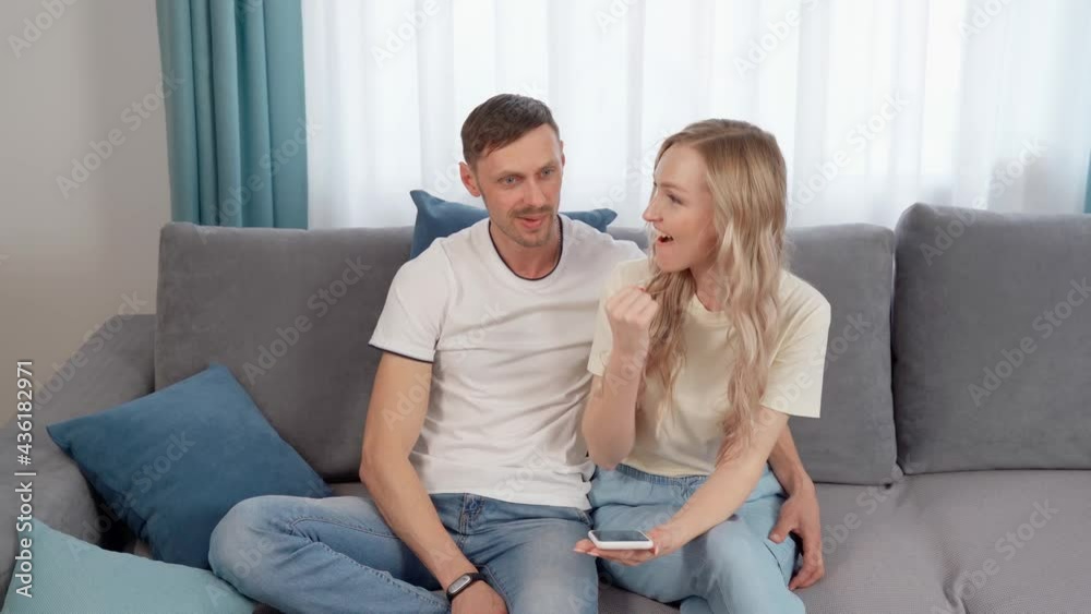 Happy husband and wife are sitting on the couch at home. Happy husband and wife are sitting on the couch at home.