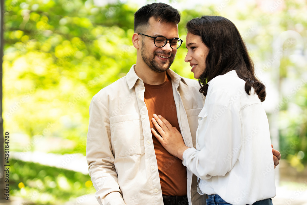Fototapeta premium Happy young couple outdoors. Loving couple walking in the city