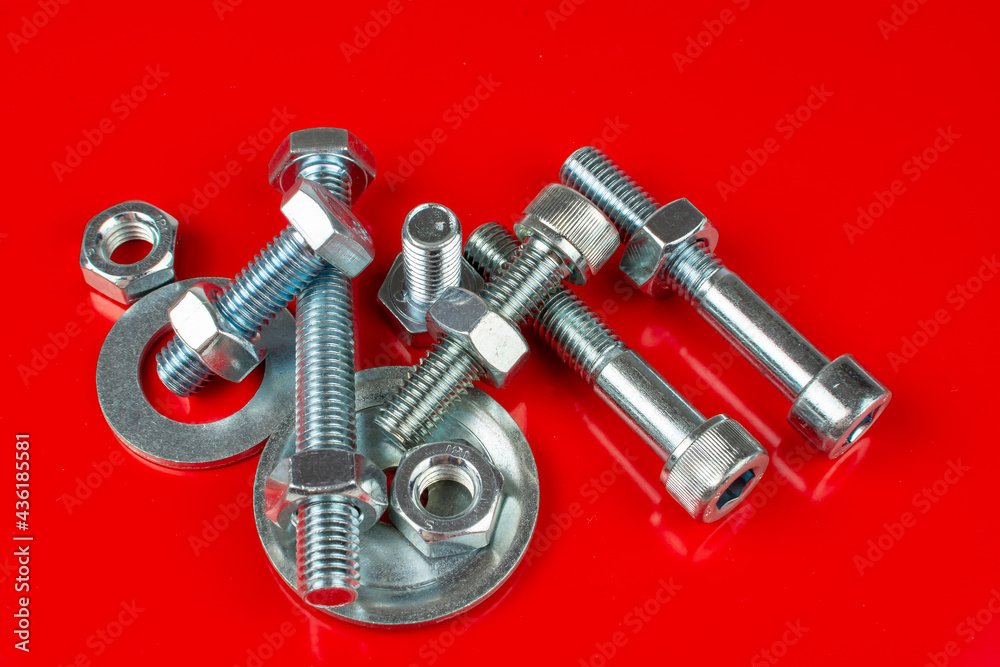 bolts and nuts for fastening structures on a red background bolts and nuts for fastening structures on a red background