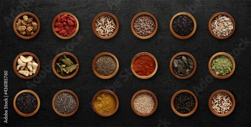 Spices in wooden bowls on a rustic wooden background, copy space