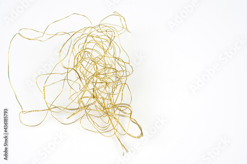 a tangle of golden copper wire on a white background