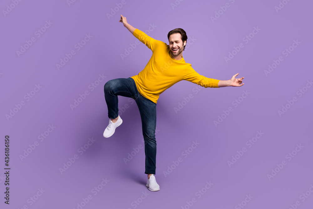 Full length body size photo smiling man in casual outfit dancing overjoyed laughing isolated pastel purple color background Full length body size photo smiling man in casual outfit dancing overjoyed laughing isolated pastel purple color background