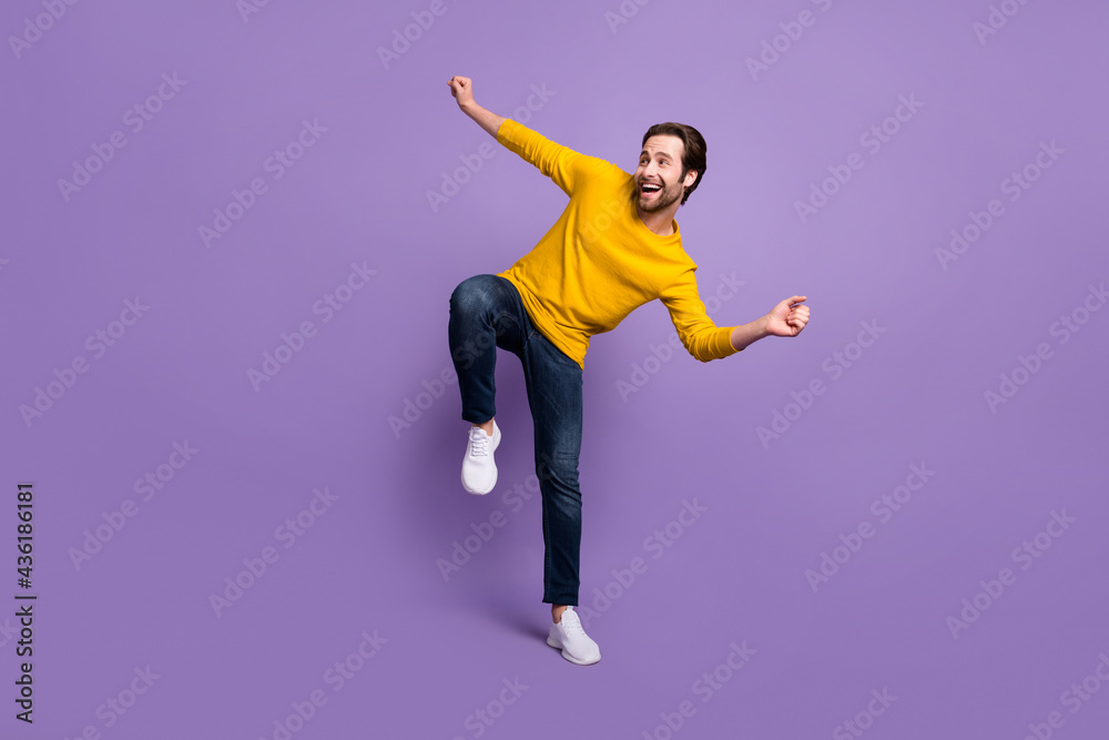 Full length body size view of attractive cheerful man dancing having fun isolated over pastel violet purple color background Full length body size view of attractive cheerful man dancing having fun isolated over pastel violet purple color background