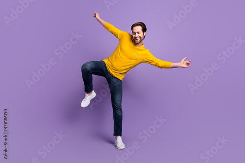 Full length body size photo smiling man in casual outfit dancing overjoyed laughing isolated pastel purple color background