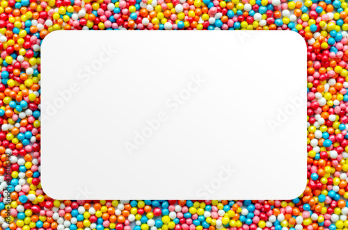 Colorful bright background, multi-colored balls. White paper blank. Sweet nice children's holiday background candy. With copy space. High quality photo