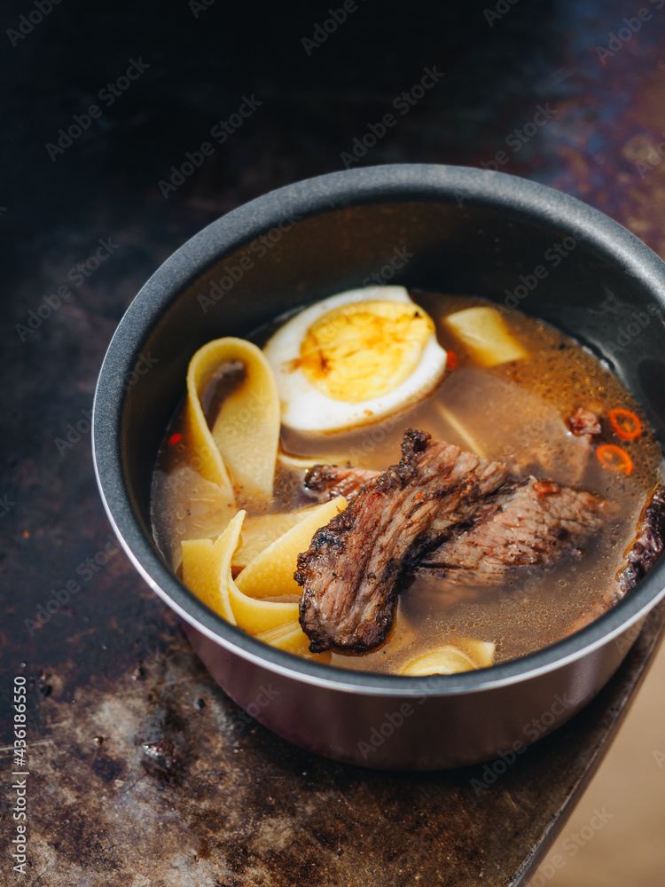 Ramen soup with egg meat brisket noodles on meatl grill Ramen soup with egg meat brisket noodles on meatl grill