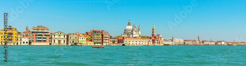 Panorama of San Marco bell tower in San Marco square in Venice with Saint Mark Basilica of the famous Venetian city of Italy. sea view from Giudecca canal by cruise boat trip in Venetian lagoon.