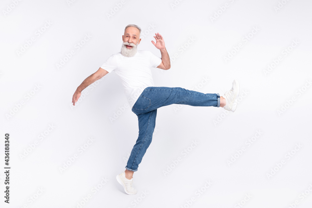 Full length body size view of nice funny cheerful man walking making step having fun isolated over light grey color background Full length body size view of nice funny cheerful man walking making step having fun isolated over light grey color background