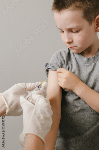 A doctor makes a vaccination to a child