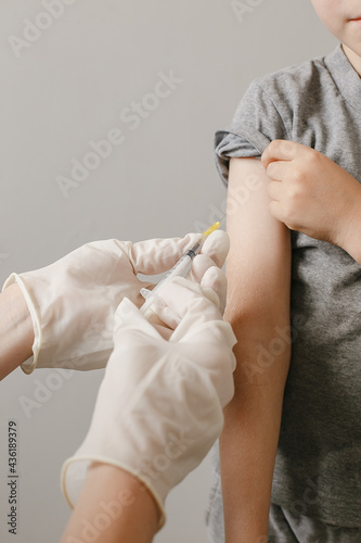 Close up Hands preparing vaccination shot to shoulder of patient