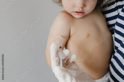 A doctor makes a vaccination to a child