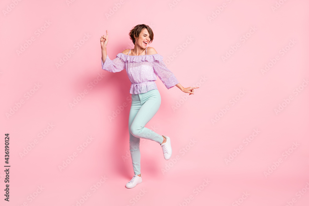 Full size photo of young attractive lovely happy excited girl dancing enjoying weekend isolated on pink color background