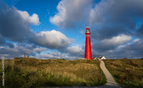 Lighthouse and clouds in the evening sun on the island of Schiermonnikoog. photo