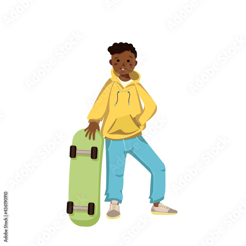 A dark skinned boy in hoodie, jeans and sneakers smiles. Happy kid with curly black hair. Afro American teenager in casual clothes and skateboard. World international children day