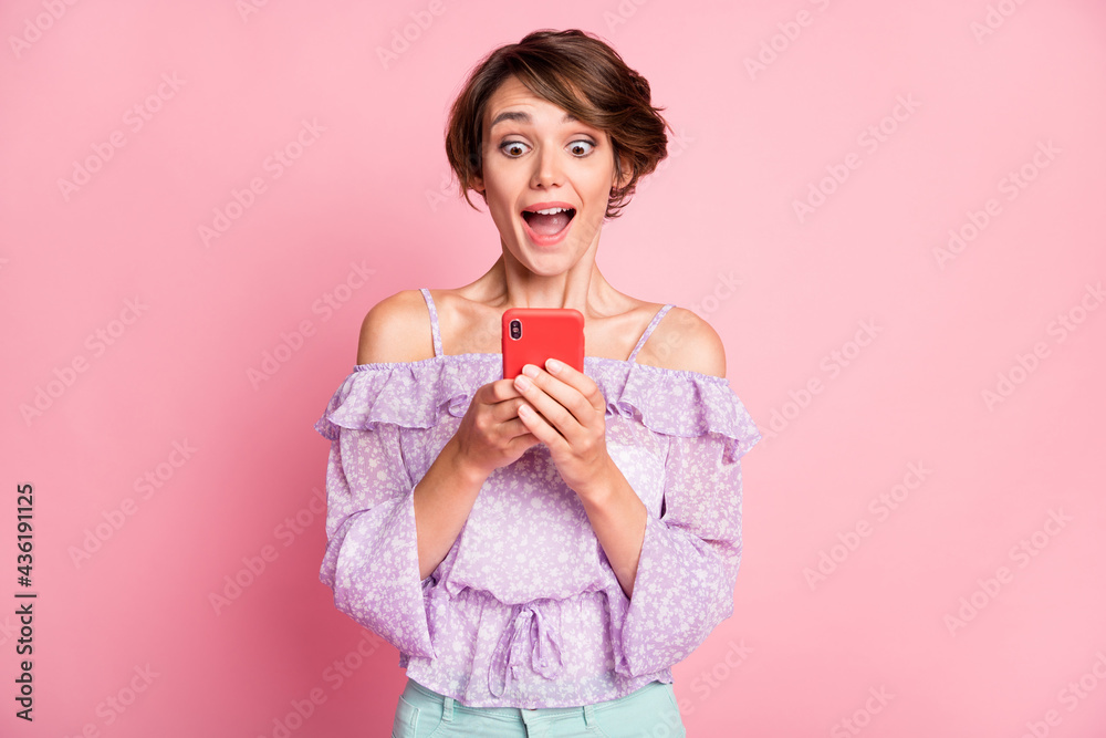 Photo of young attractive lovely excited happy amazed girl see many likes in phone isolated on pink color background Photo of young attractive lovely excited happy amazed girl see many likes in phone isolated on pink color background
