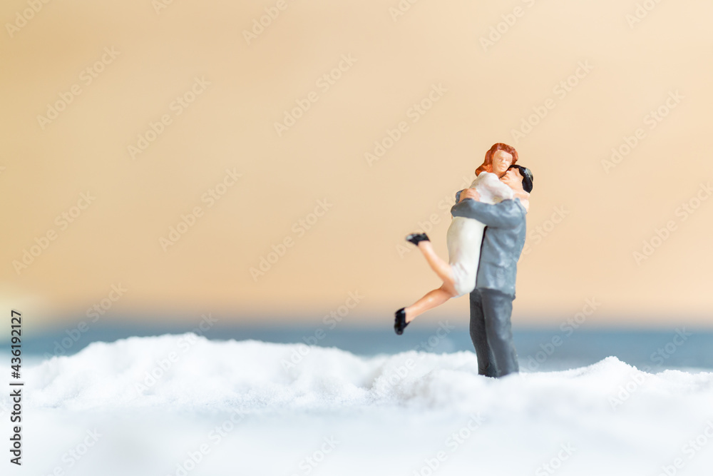 Miniature people Happy wedding couple on white beach , wedding concept Miniature people Happy wedding couple on white beach , wedding concept