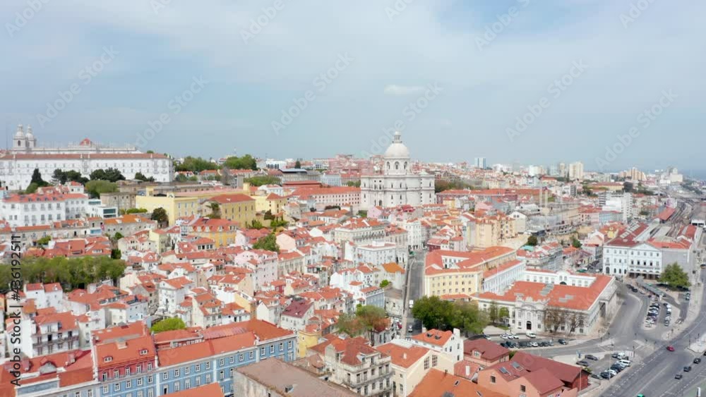 Aerial wide dolly in view of colorful traditional old houses and Church of Santa Engracia on the hills urban city center of Lisbon, Portugal Aerial wide dolly in view of colorful traditional old houses and Church of Santa Engracia on the hills urban city center of Lisbon, Portugal