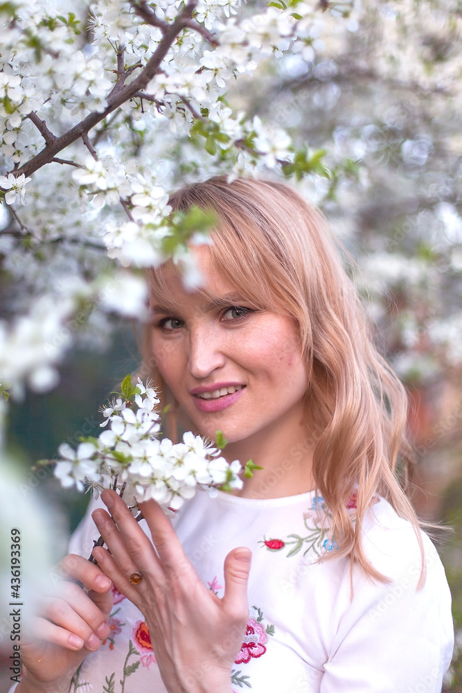 beautiful young blonde woman standing near the apple tree beautiful young blonde woman standing near the apple tree