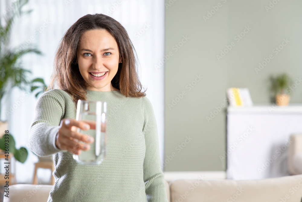 Woman drinking water at home Woman drinking water at home