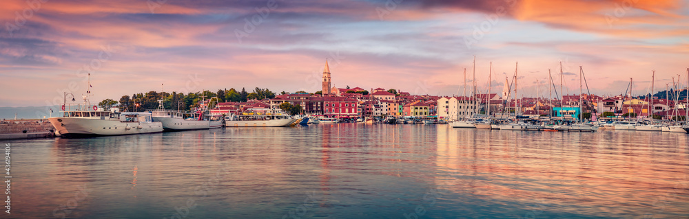 Panoramic evening cityscape of old fishing town Isola. Amazing spring seascape of Adriatic Sea. Beautiful outdoor scene of Slovenia, Europe. Traveling concept background.