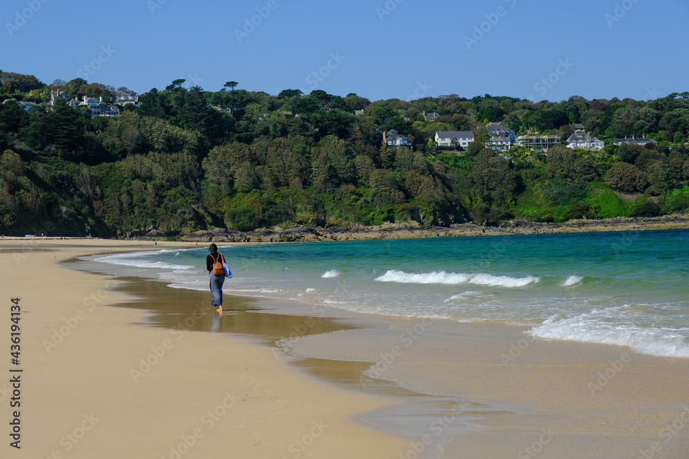Woman on beach at Carbis Bay close t St Ives in Cornwall, UK.