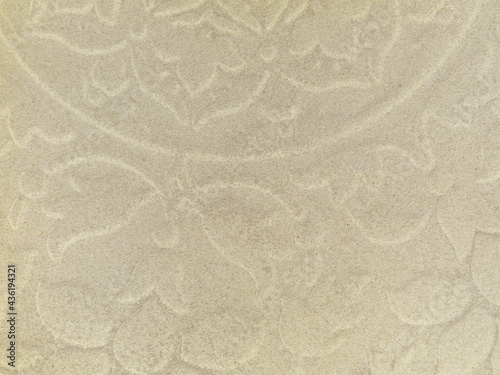 Cardboard background with an embossed floral pattern in an irregular shape. 