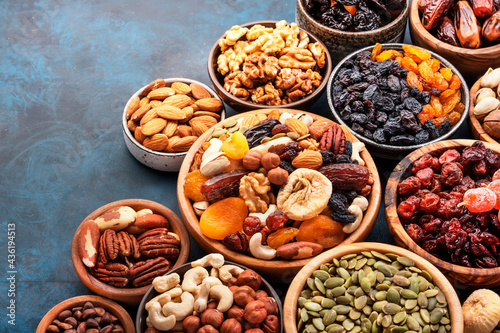 Nuts and dried fruits. Dried apricots, figs, raisins, pecans, walnuts, hazelnuts, almonds and other. Blue background, top view