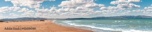 Famous Delta del Ebro beach called  fangar  beach situated in Tarragona  Spain. Picture captured in a sunny day with clouds in the sky. 