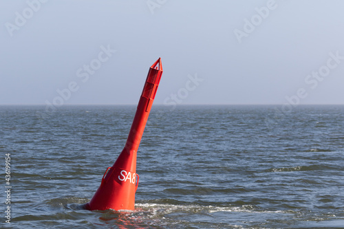 Red spar buoy swims in the North Sea off Hallig Hooge