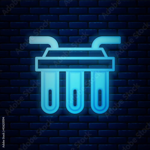 Glowing neon Water filter icon isolated on brick wall background. System for filtration of water. Reverse osmosis system. Vector
