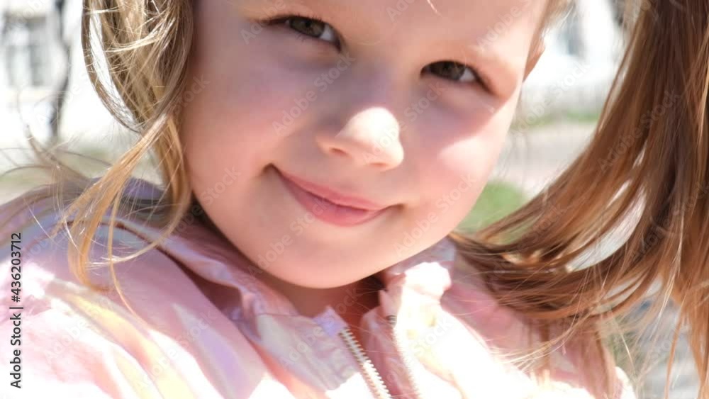 Day dreaming and happy cute child girl in summer outdoors.