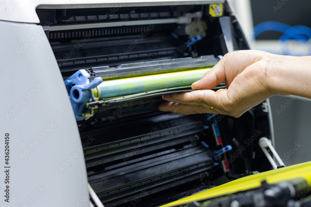 Technicians replacing toner in laser printer concept office supplies repair Technicians replacing toner in laser printer concept office supplies repair