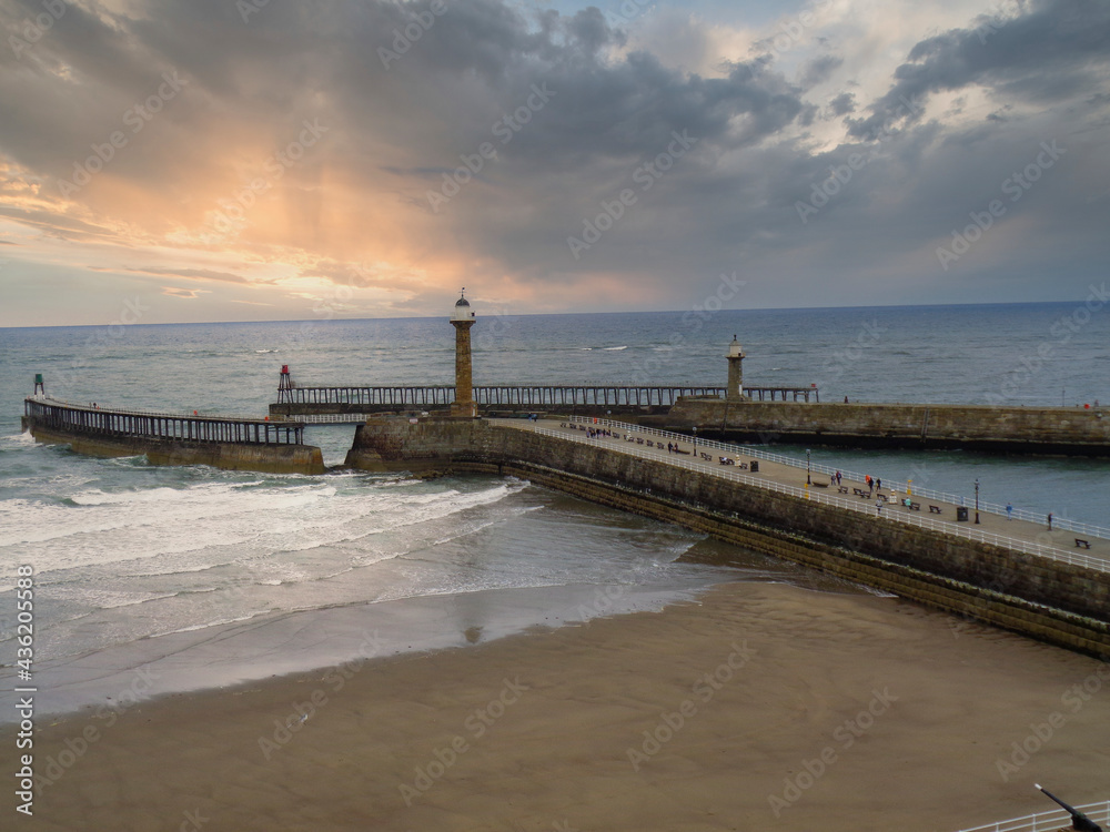 a pier in England by stormy weather during the summer