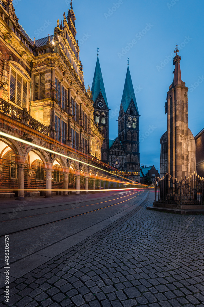 A tram passing Bremen City Hall with the Bremen Cathedral behind