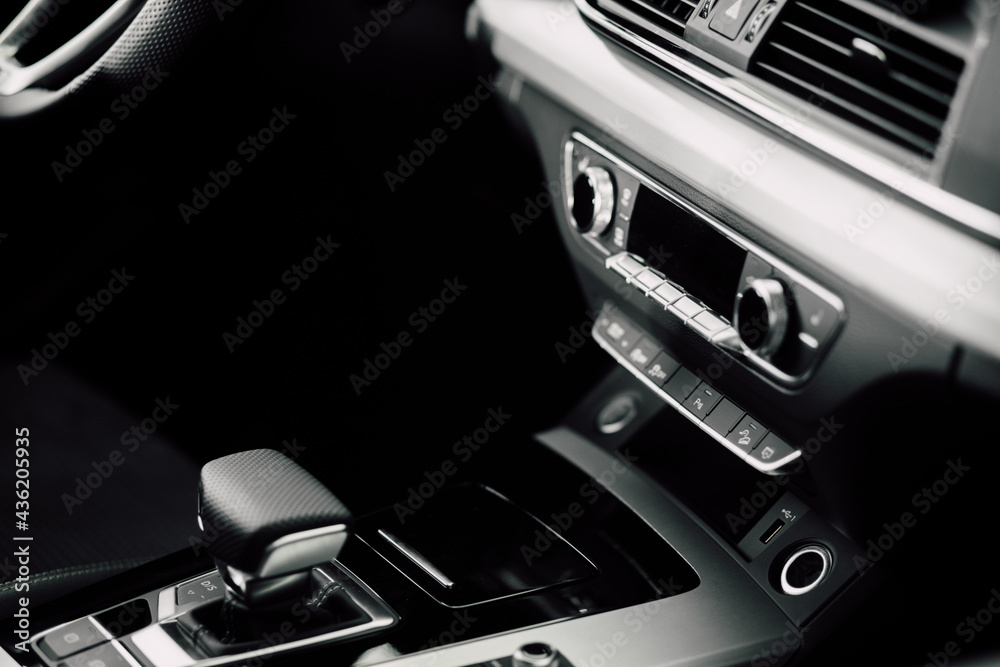 Interior Design of New Car. Automatic gearbox and media controller close up. Details inside car. Detail of luxury car interior.