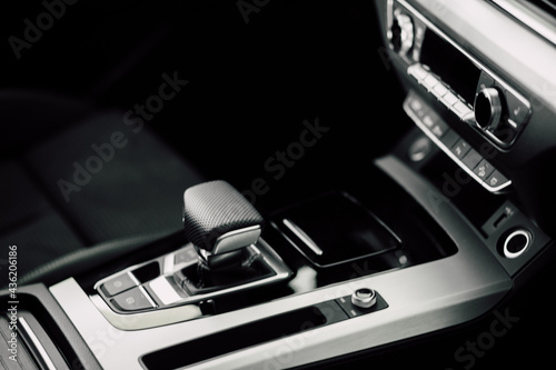Interior Design of New Car. Automatic gearbox and media controller close up. Details inside car. Detail of luxury car interior.
