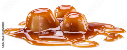 Foto Caramel candies covered with melted sugar caramel isolated on white background