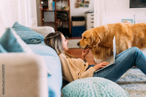 Young woman with dog at home photo