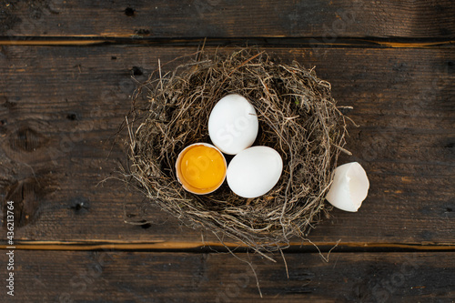Fresh eggs in the nest on a rustic background
