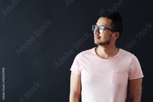 Young handsome man with beard wearing casual t shirt and glasses over black background face smiling with crossed arms looking at the camera. Positive person. © arthurhidden