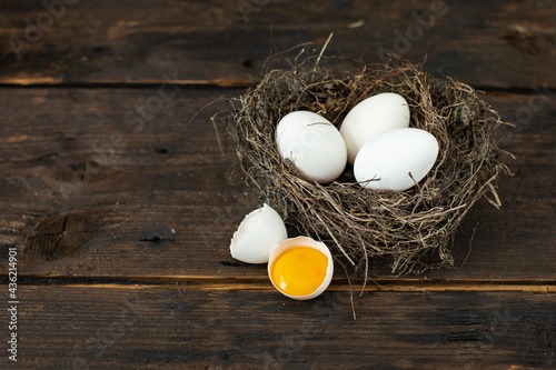 Fresh eggs in the nest on a rustic background