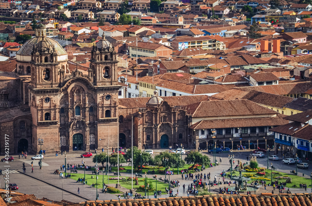 Aerial view of rooftops and main square (barrack square) in Cusco city. Cathedral, houses and churches from a fair away point. Peru, South America