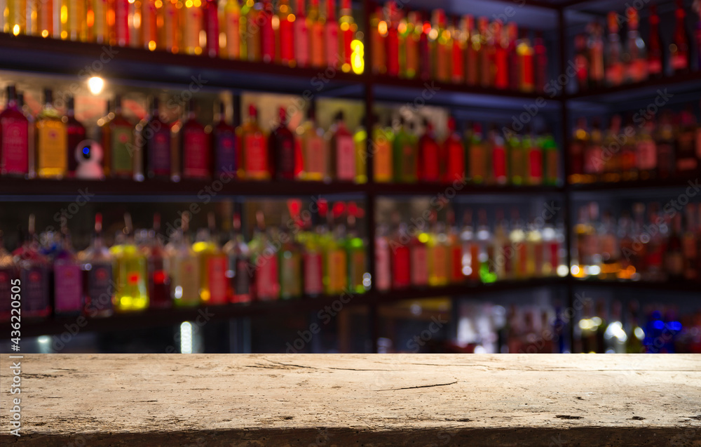 Classic bar counter with bottles in blurred background Classic bar counter with bottles in blurred background
