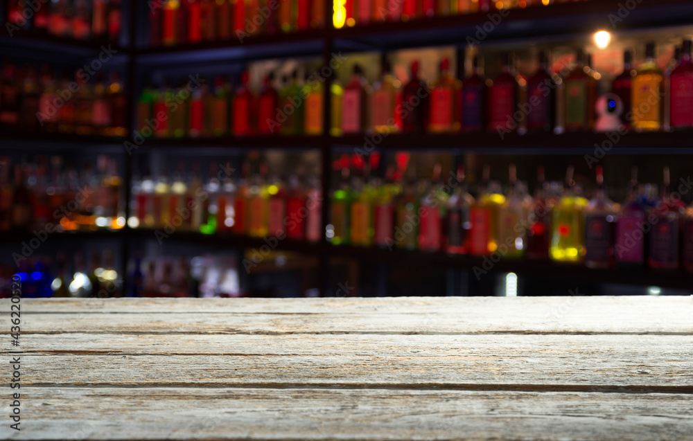 Classic bar counter with bottles in blurred background Stock Photo ...