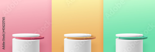 Set of green, yellow, pink round cylinder pedestal podium display on empty room background. Abstract modern vector rendering 3d shape for cosmetic products presentation. Pastel minimal scene room.
