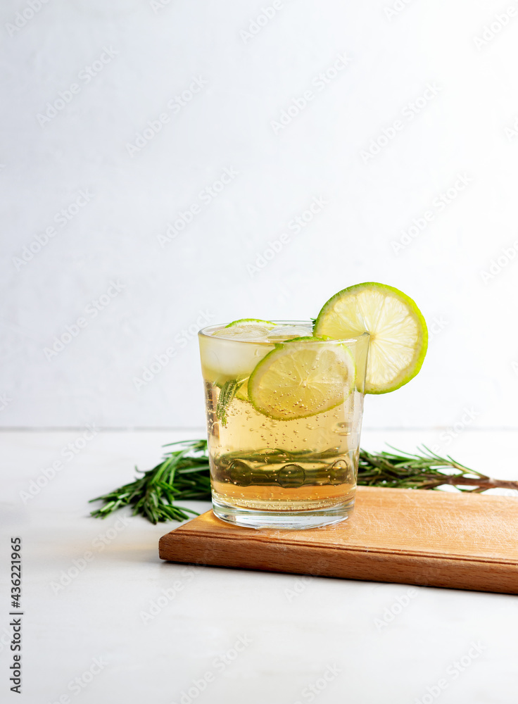 Fototapeta premium Cold fresh summer lemonade with lime and rosemary in glass