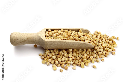 dried peas in wooden scoop isolated on white background